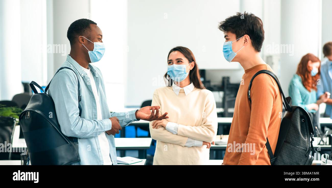 International students wearing medical masks and talking Stock Photo ...