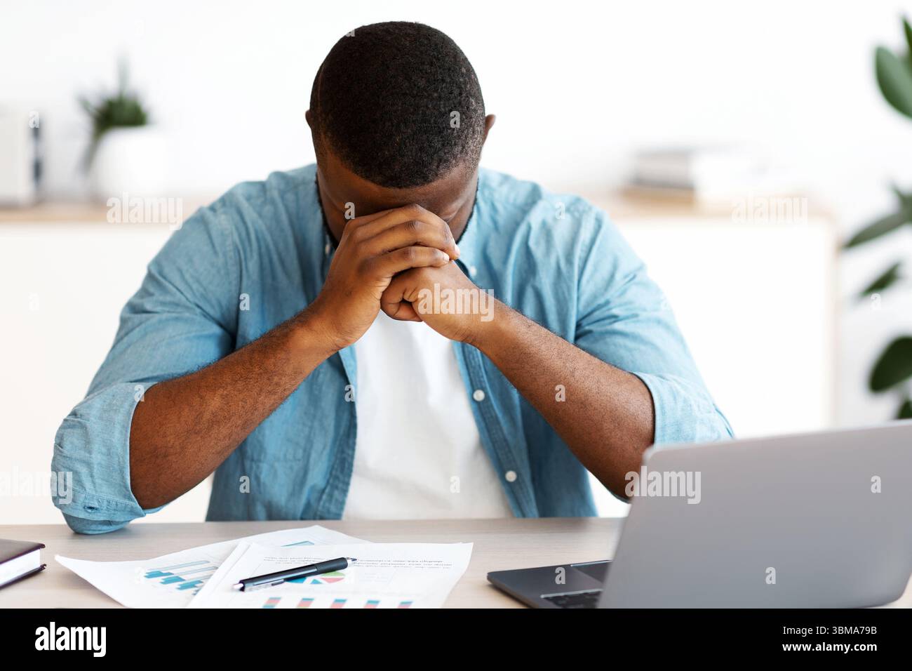 Depressed African American Entrepreneur Having Problems At Work Stock Photo