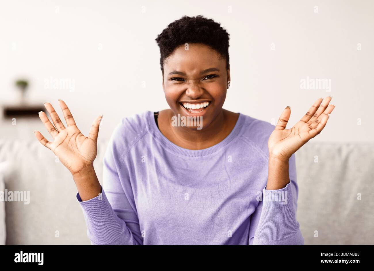 Portrait of casual young black woman laughing Stock Photo - Alamy