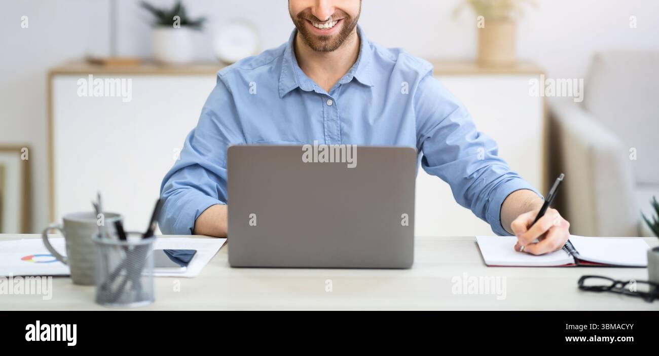 Business Guy Working Taking Notes Sitting At Laptop In Office Stock Photo