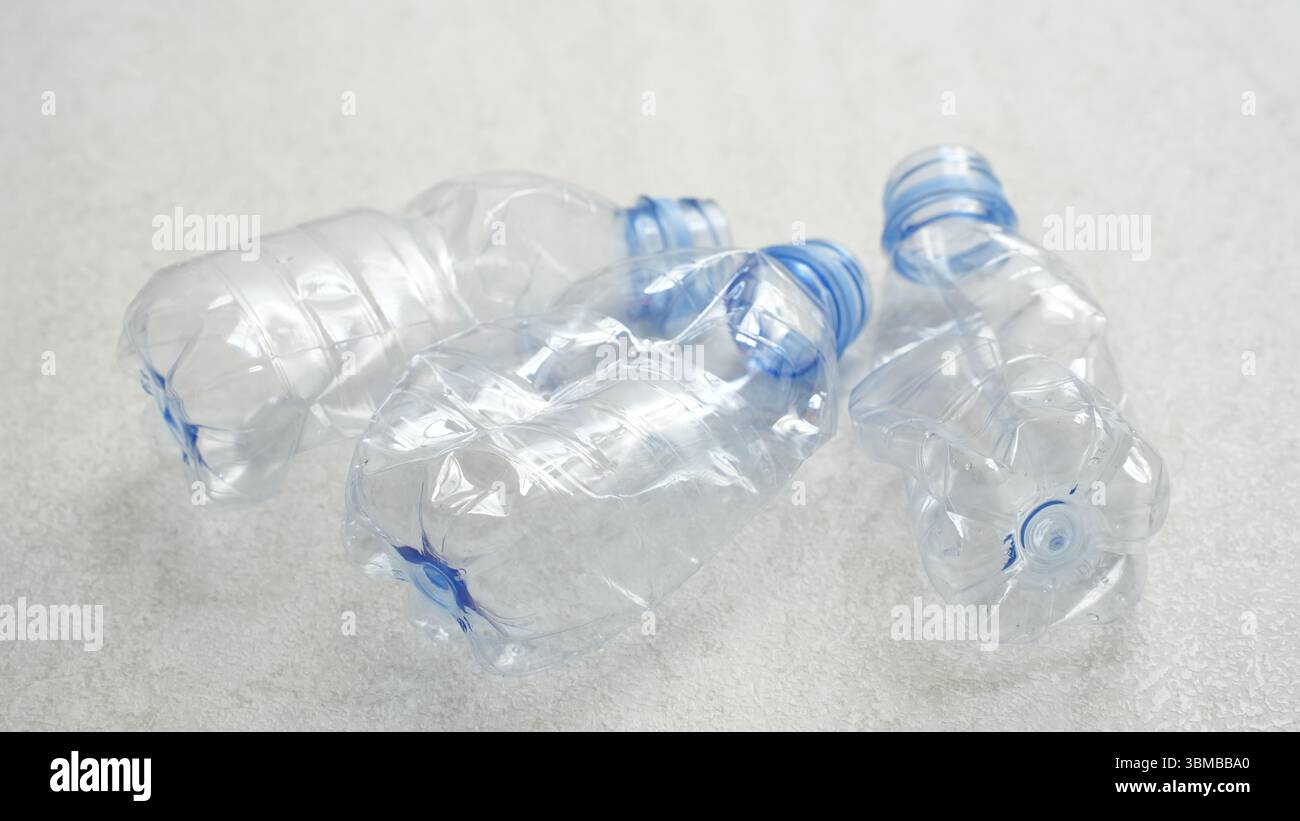 Empty rumpled used or crushed used plastic bottles isolated on white background Stock Photo