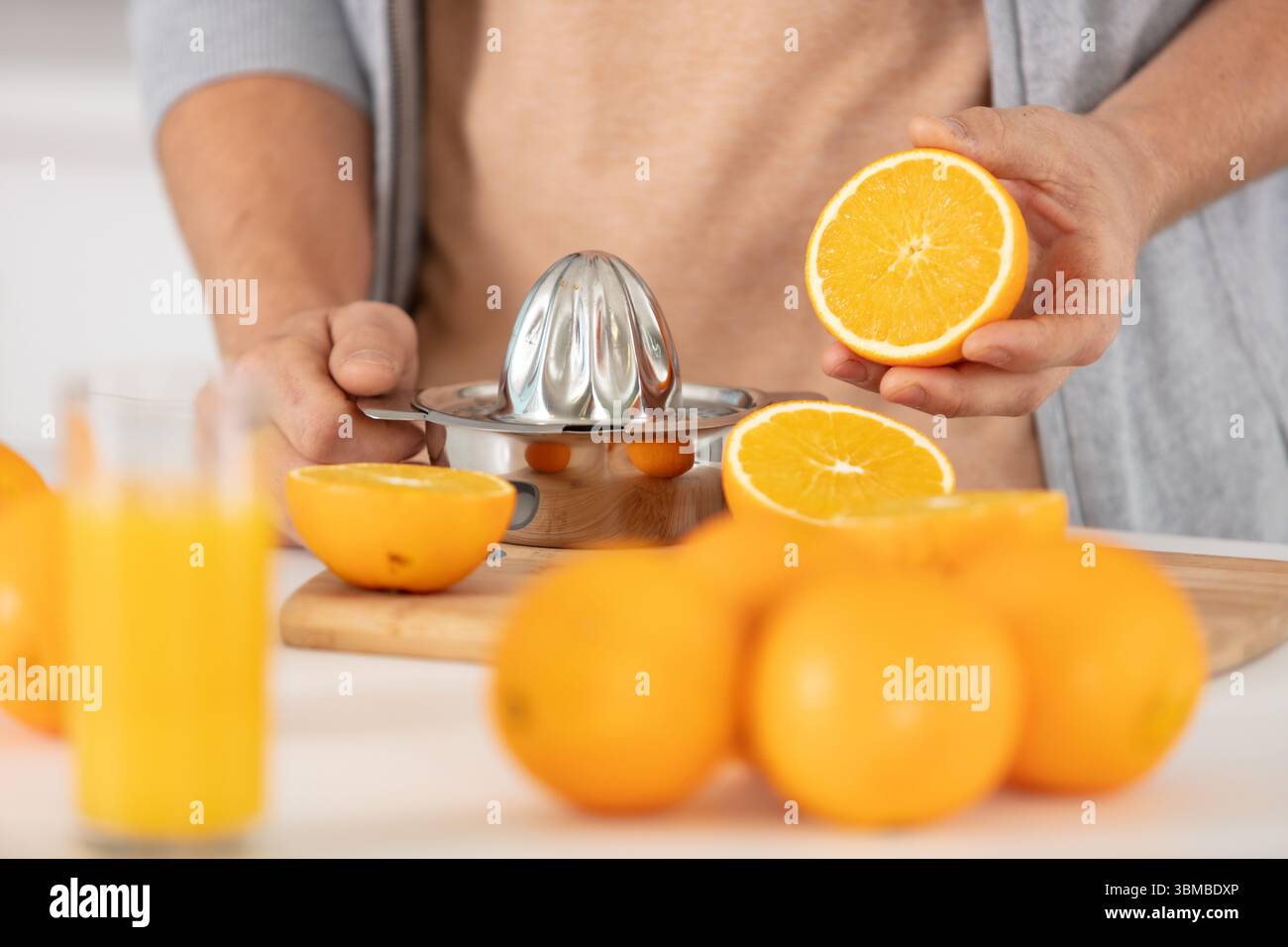 closeup on man making orange juice Stock Photo