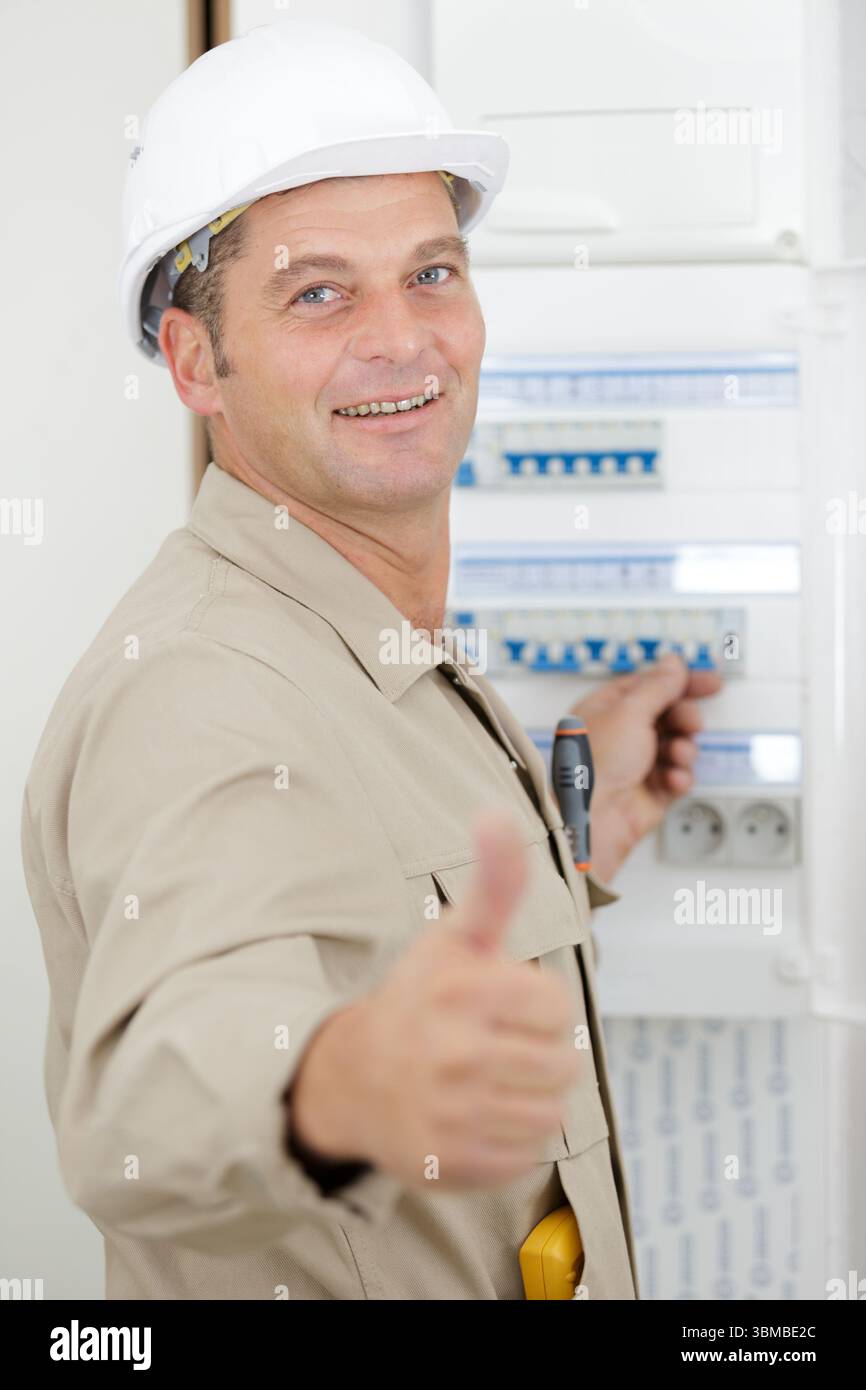 electrician installing energy saving meter Stock Photo