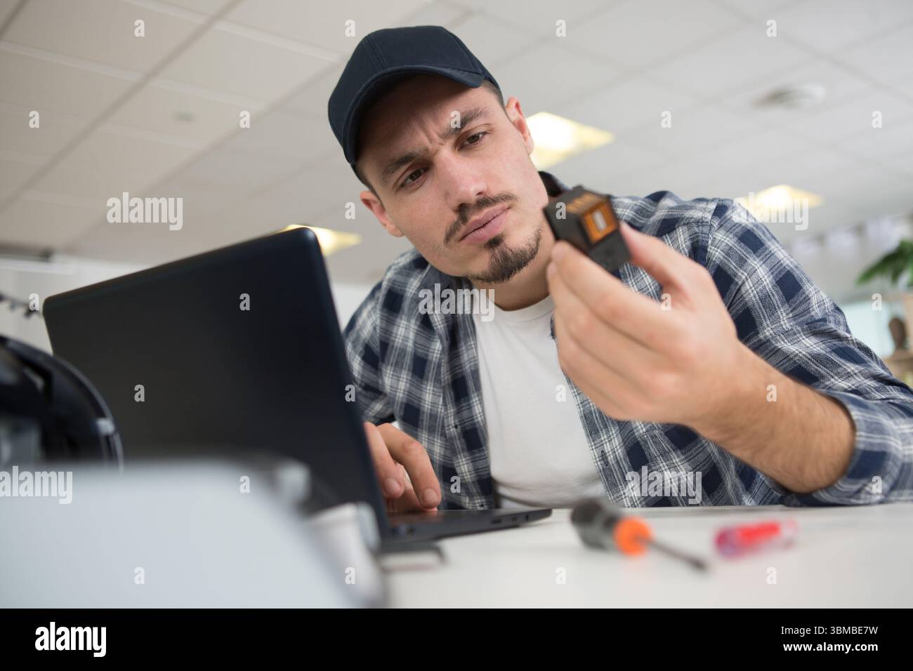 male employee checking the printer and ink Stock Photo
