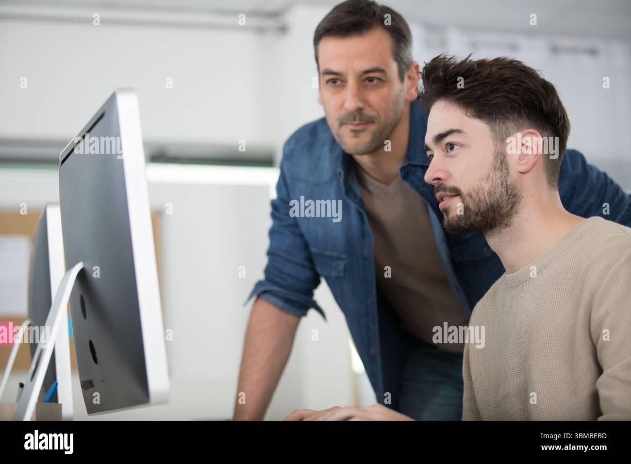 two entrepreneurs working and taking notes together in the office Stock Photo