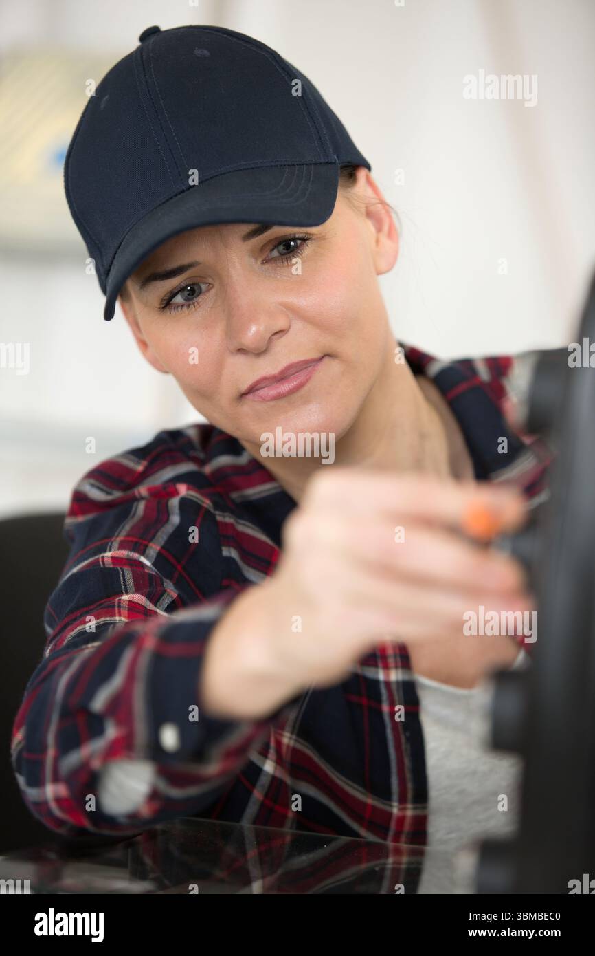 young female technician fixing printer Stock Photo