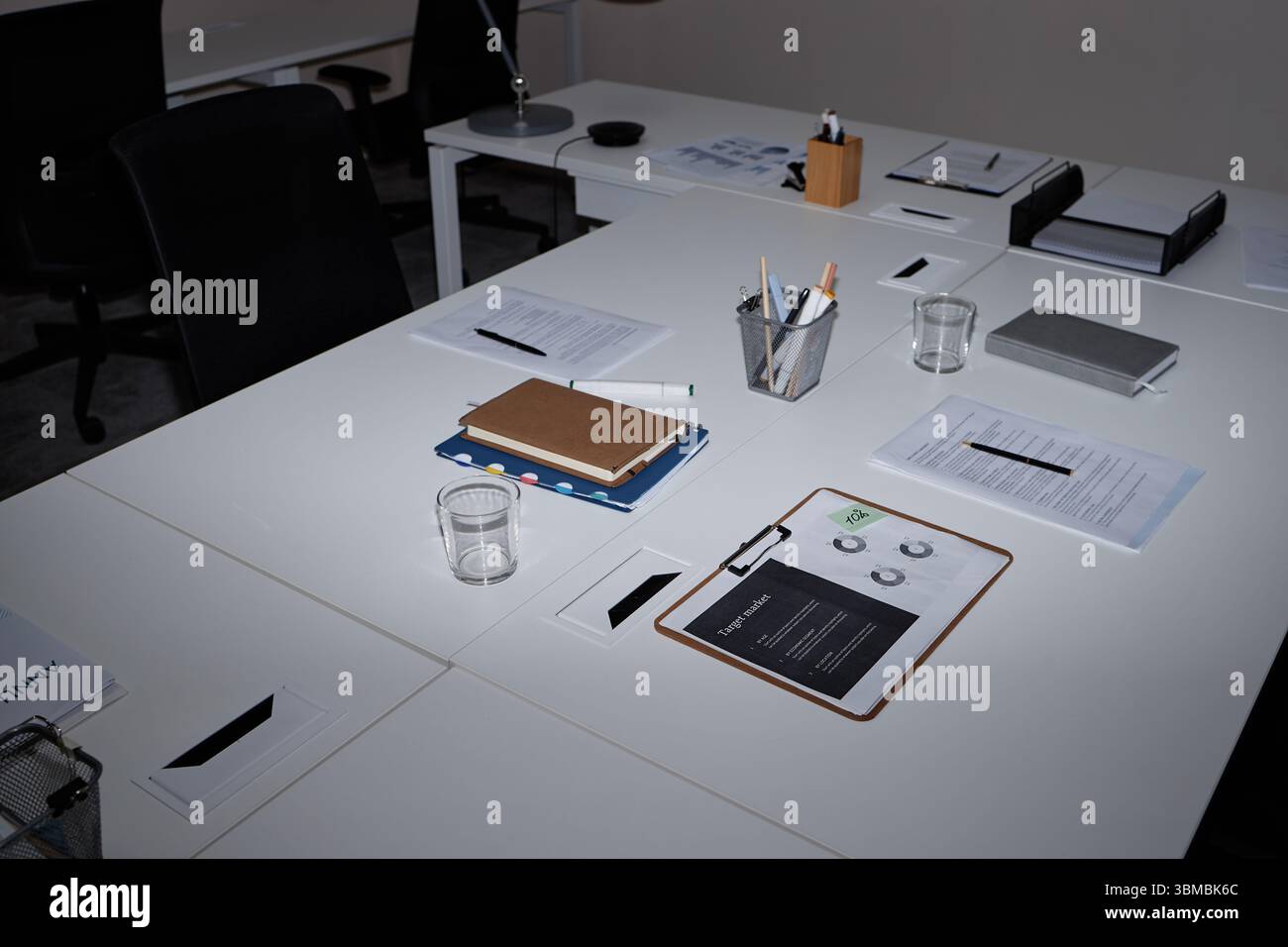Empty Modern Office Workspace Featuring Documents and Stationery on Desk Stock Photo