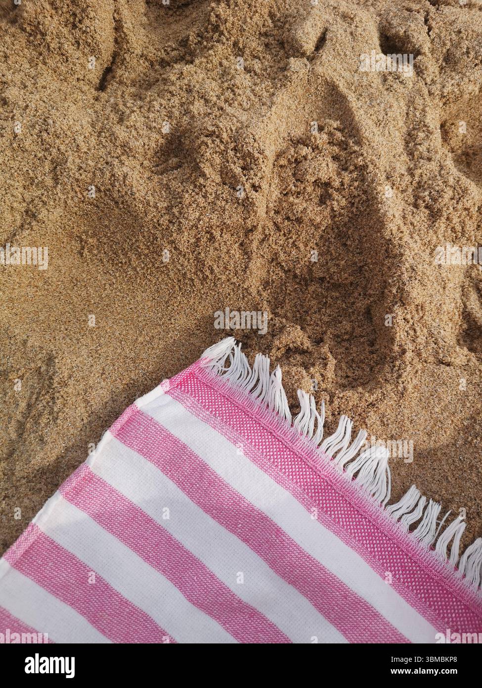 Striped white and Pink Beach Towel with golden sand - Smartphone Captured Stock Image