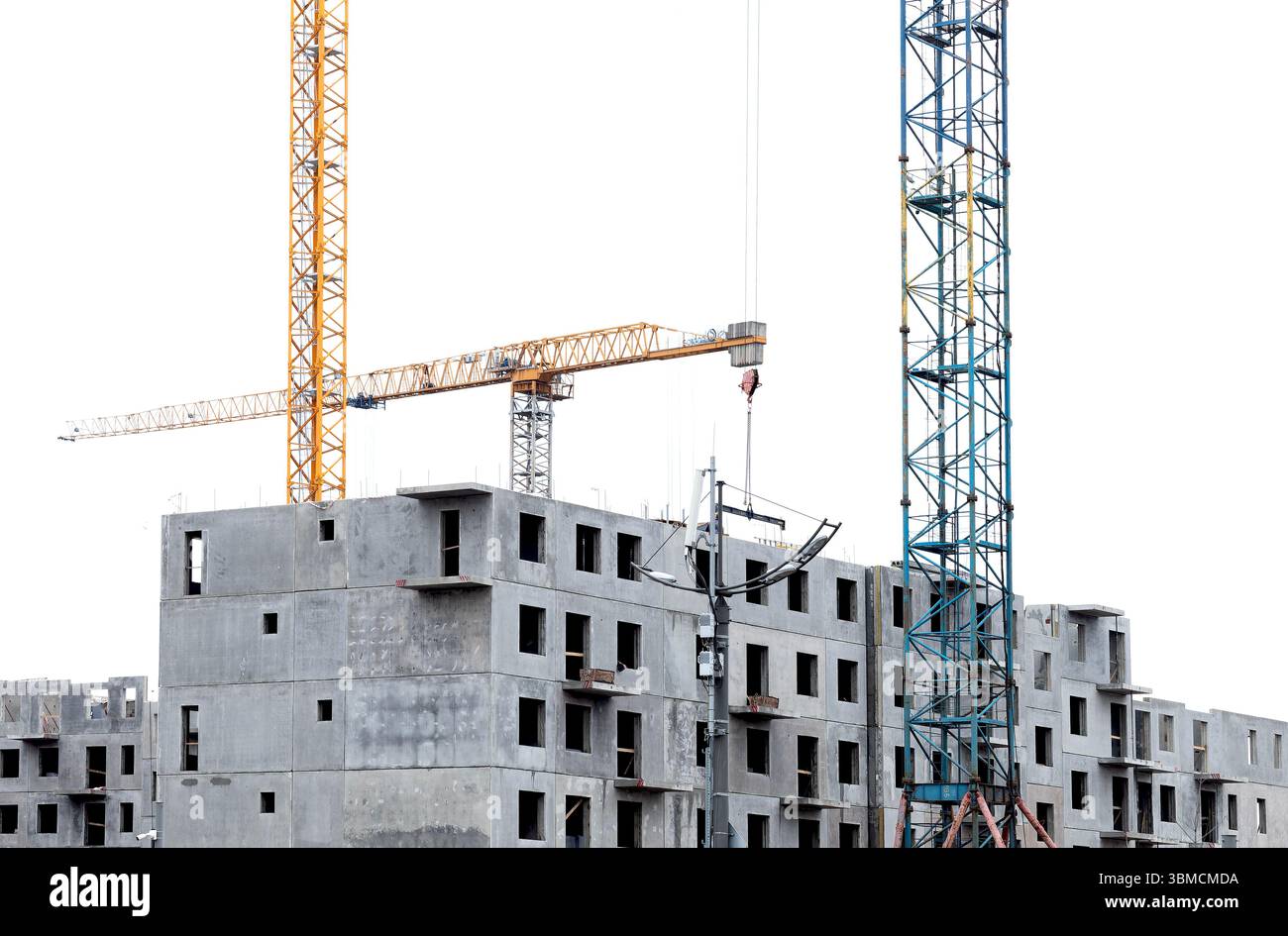 Urban construction site with a crane working on a modern high-rise ...