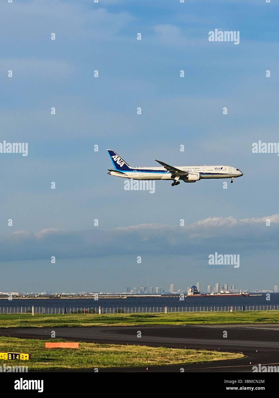 ANA Boeing 787 Landing at Tokyo Haneda Airport - Wide-Body Jet Approaching Runway over Tokyo Bay Stock Photo