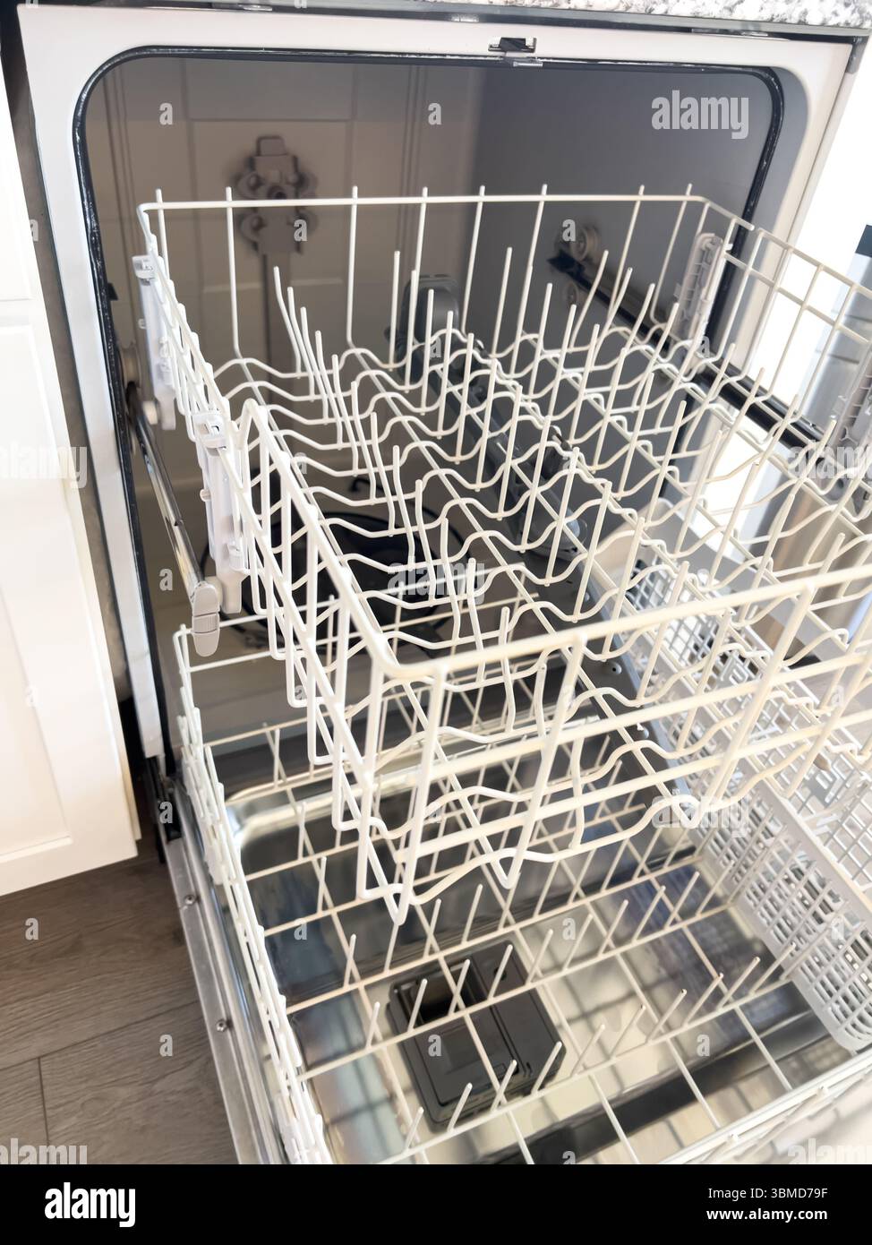 Bottom Rack of Open Dishwasher in Kitchen Stock Photo - Alamy
