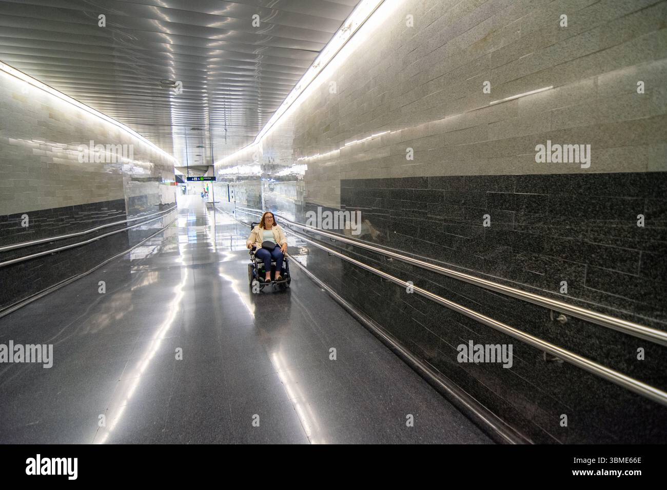 Hand Rails Subway Woman using wheelchair navigating subway corridor with handrails ...