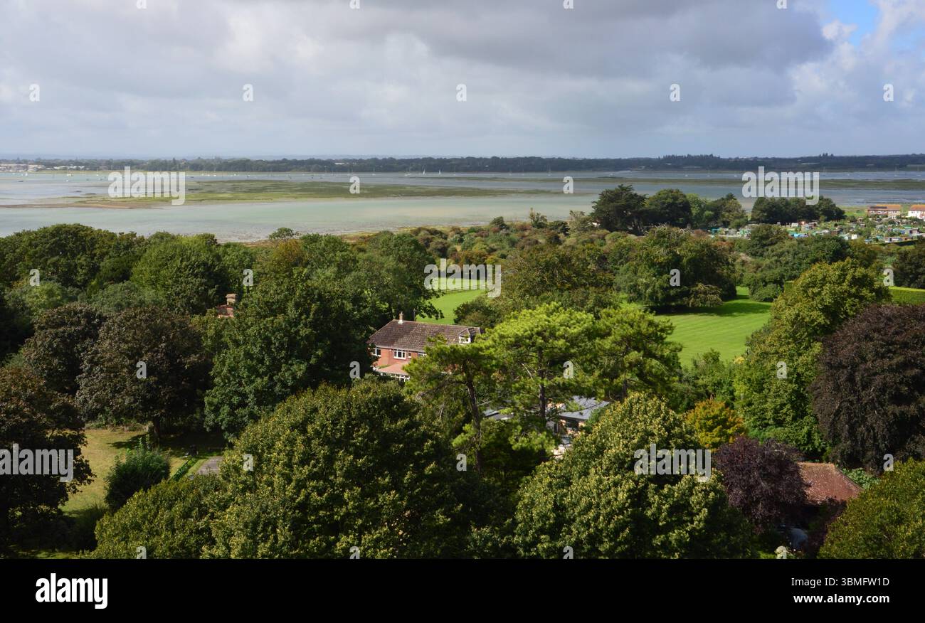 A scenic view from the tower of Portchester Castle, overlooking the lush green landscape and tidal flats of Portsmouth Harbour, Hampshire, England. Stock Photo