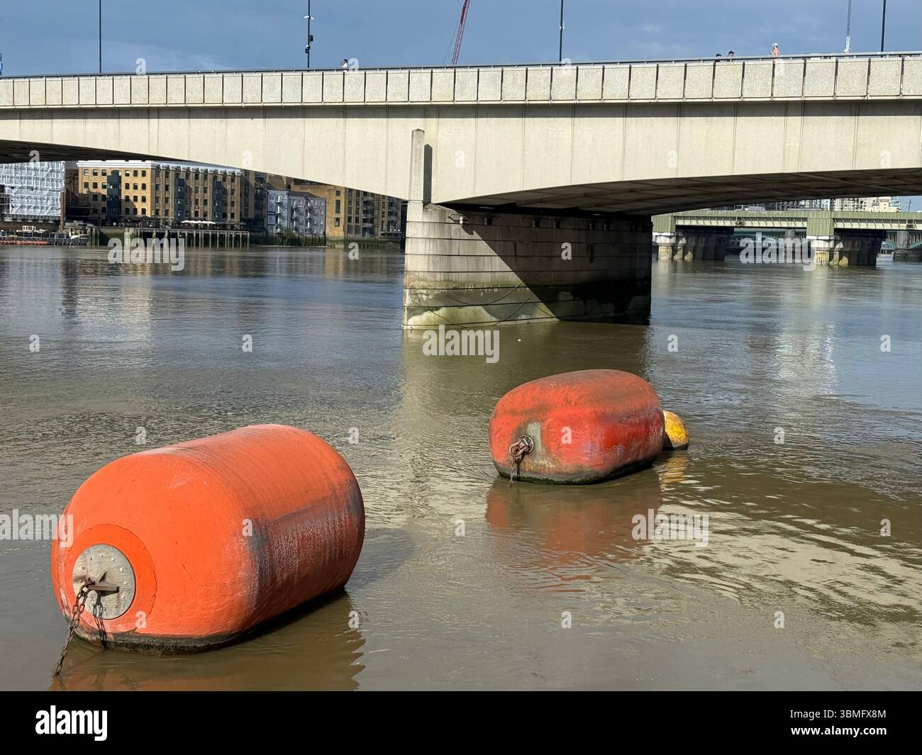 Orange floats on Thames with London Bridge in background - Smartphone Captured Stock Image