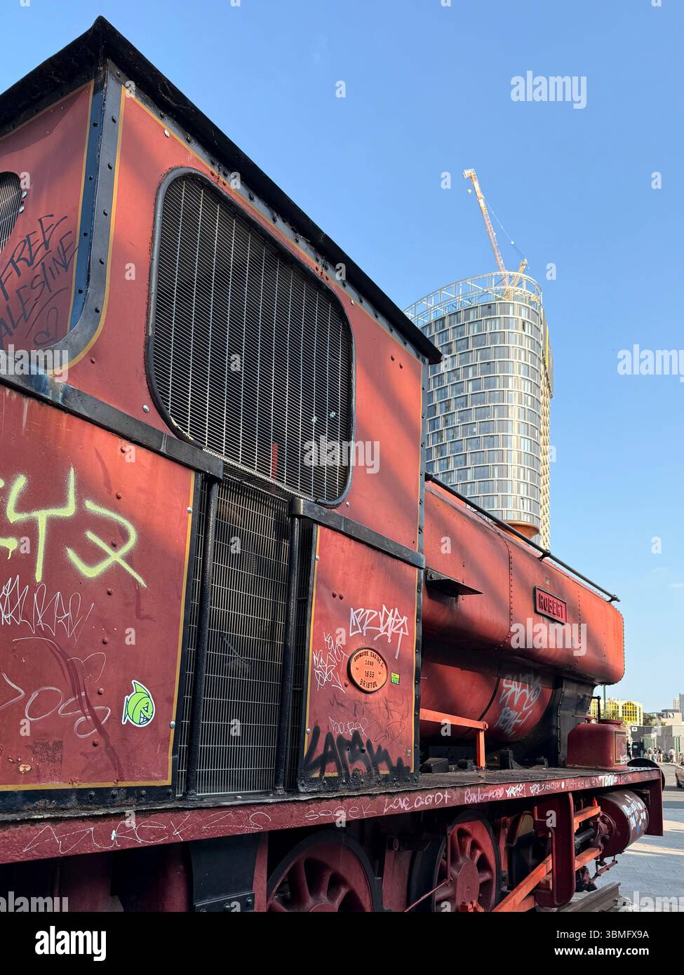 Old steam engine (Robert) covered in graffiti in Stratford town centre - Smartphone Captured Stock Image