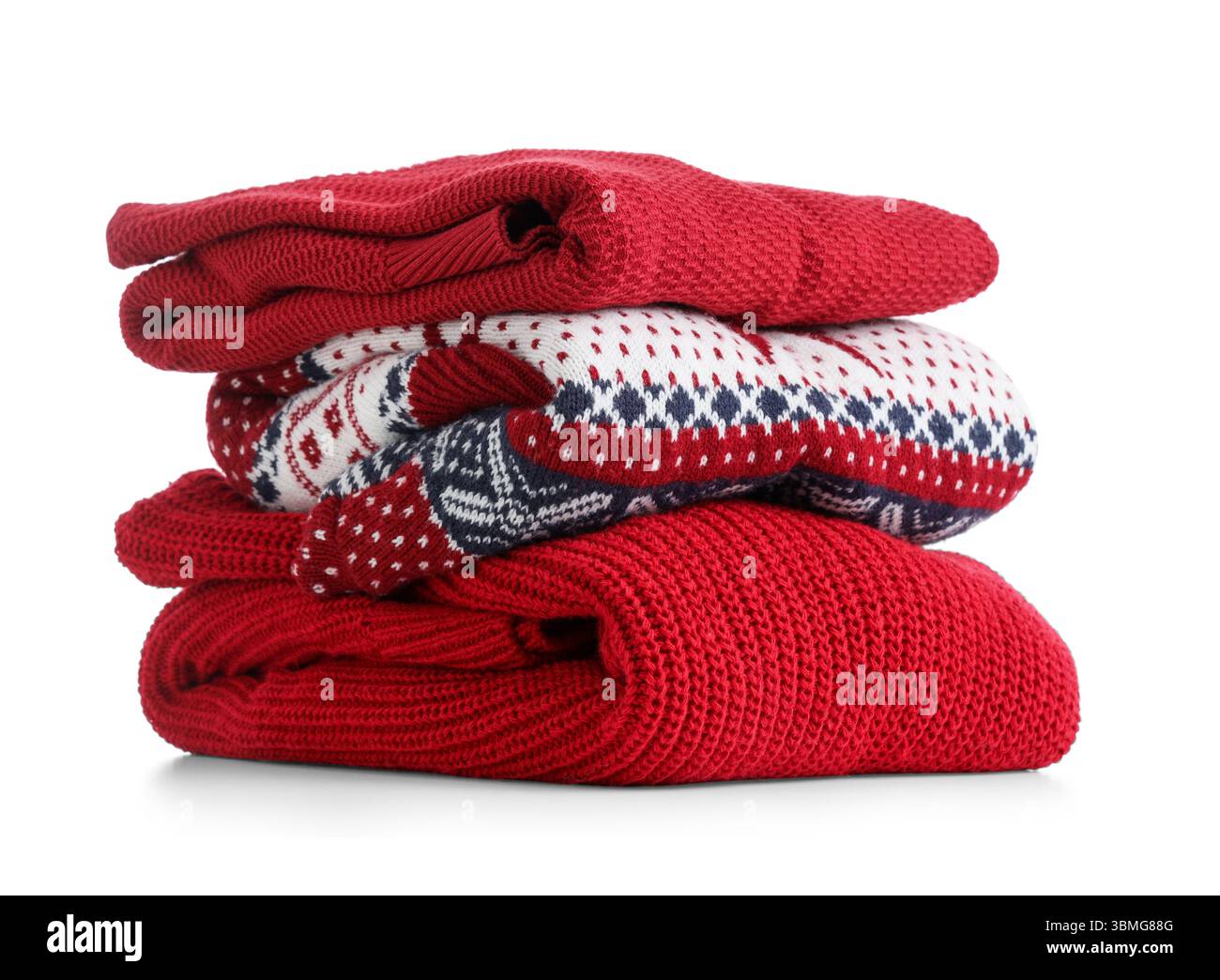 Stack of clean sweaters isolated on white background Stock Photo