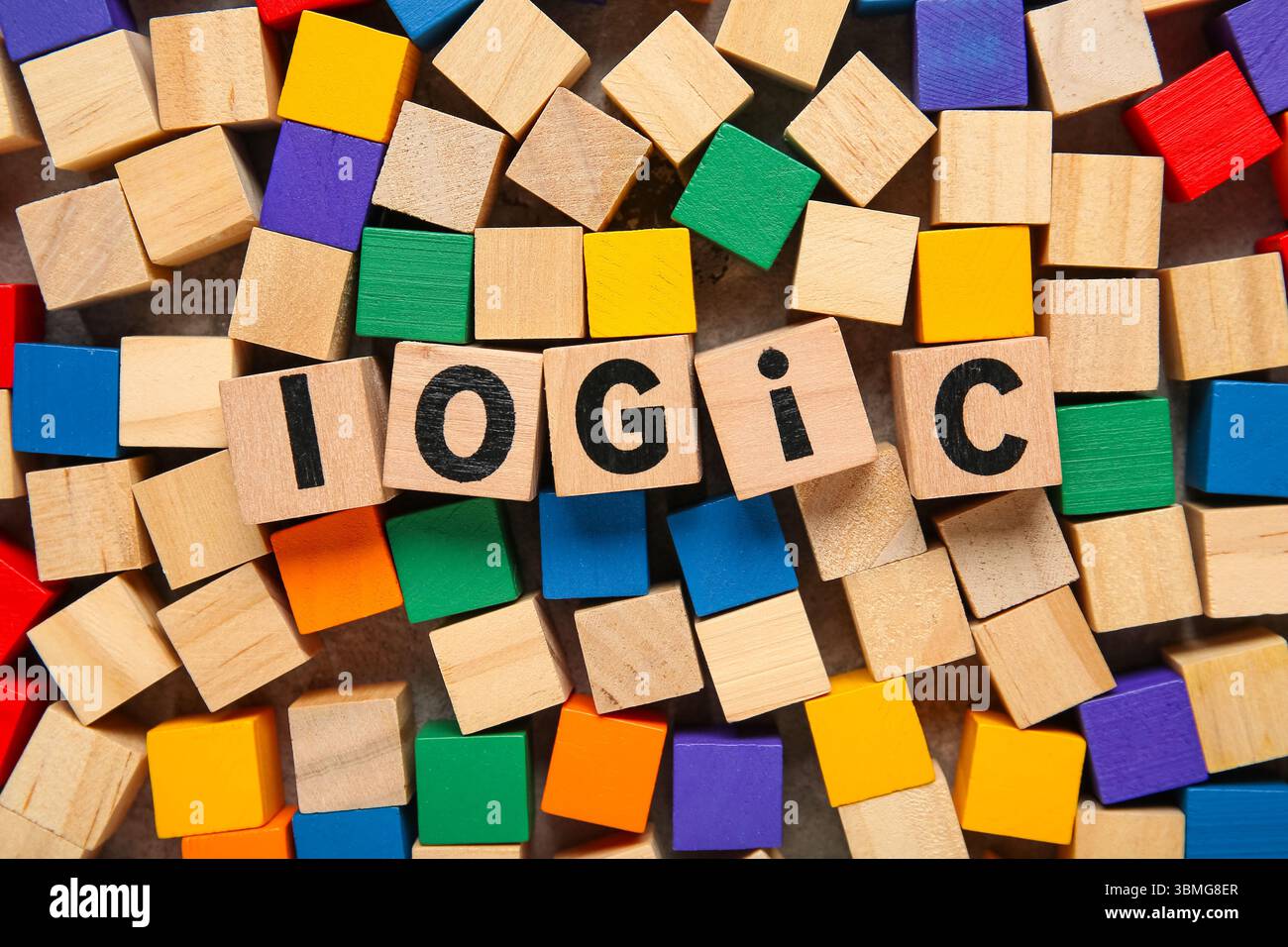 Many different colorful wooden cubes with word LOGIC on grey background, closeup Stock Photo