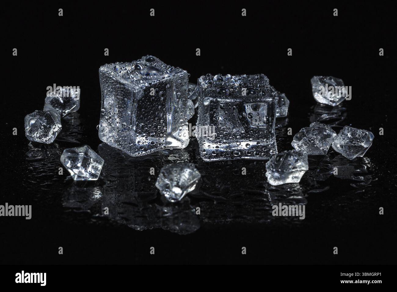 Ice cubes on black isolated glass background Stock Photo