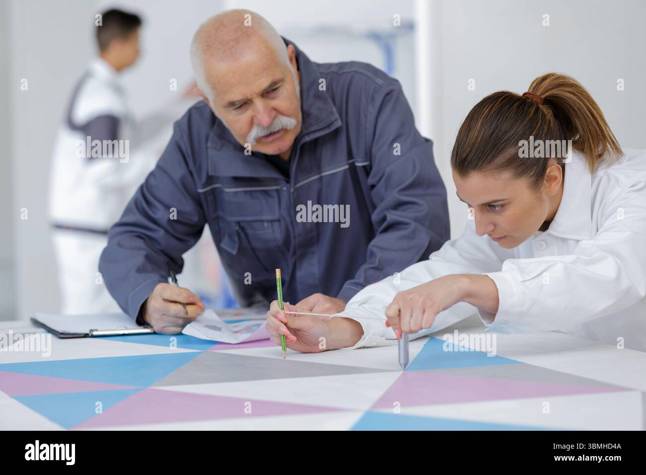 female apprentice decorator in training Stock Photo
