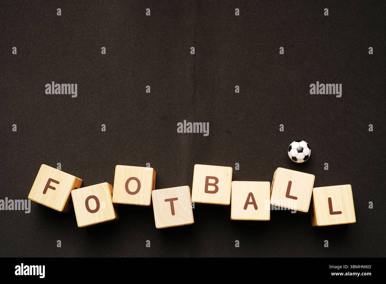 football writing from wooden cube blocks on black background Stock ...