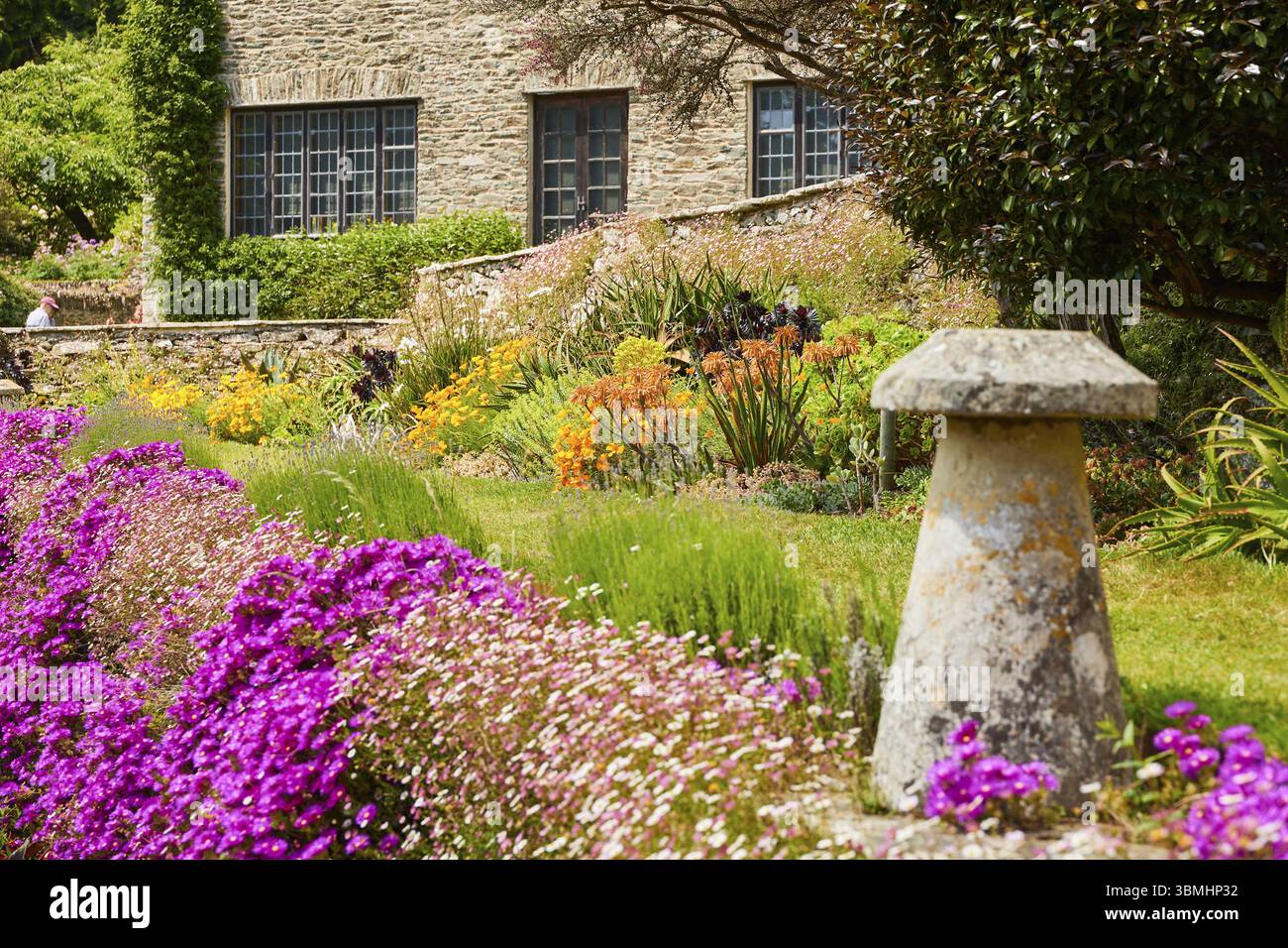 Rustic country house with colourful garden of colourful flowers and ...