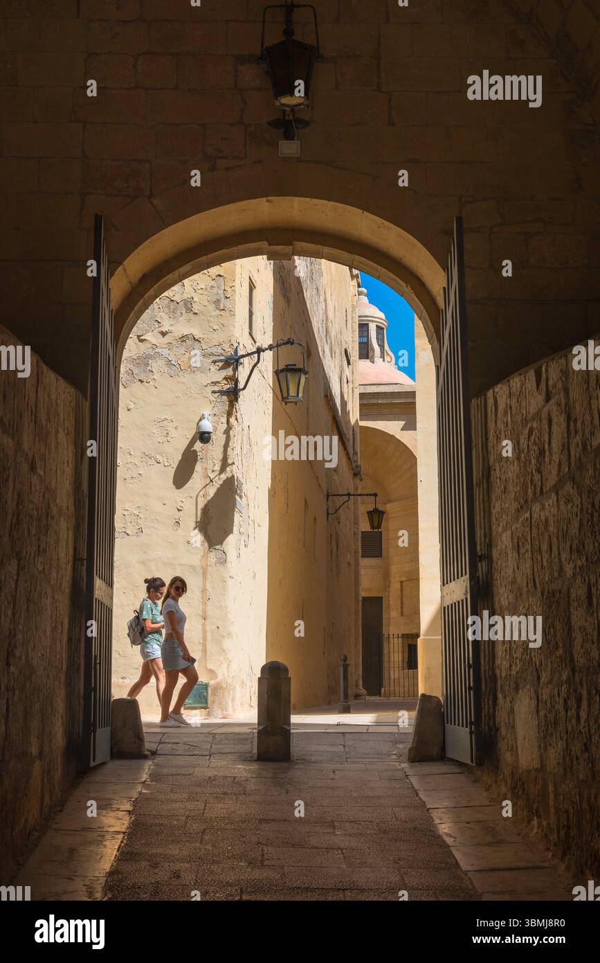 Mdina old city, view of two young female tourists exploring the scenic streets of the historic walled city of the Mdina, Malta Stock Photo