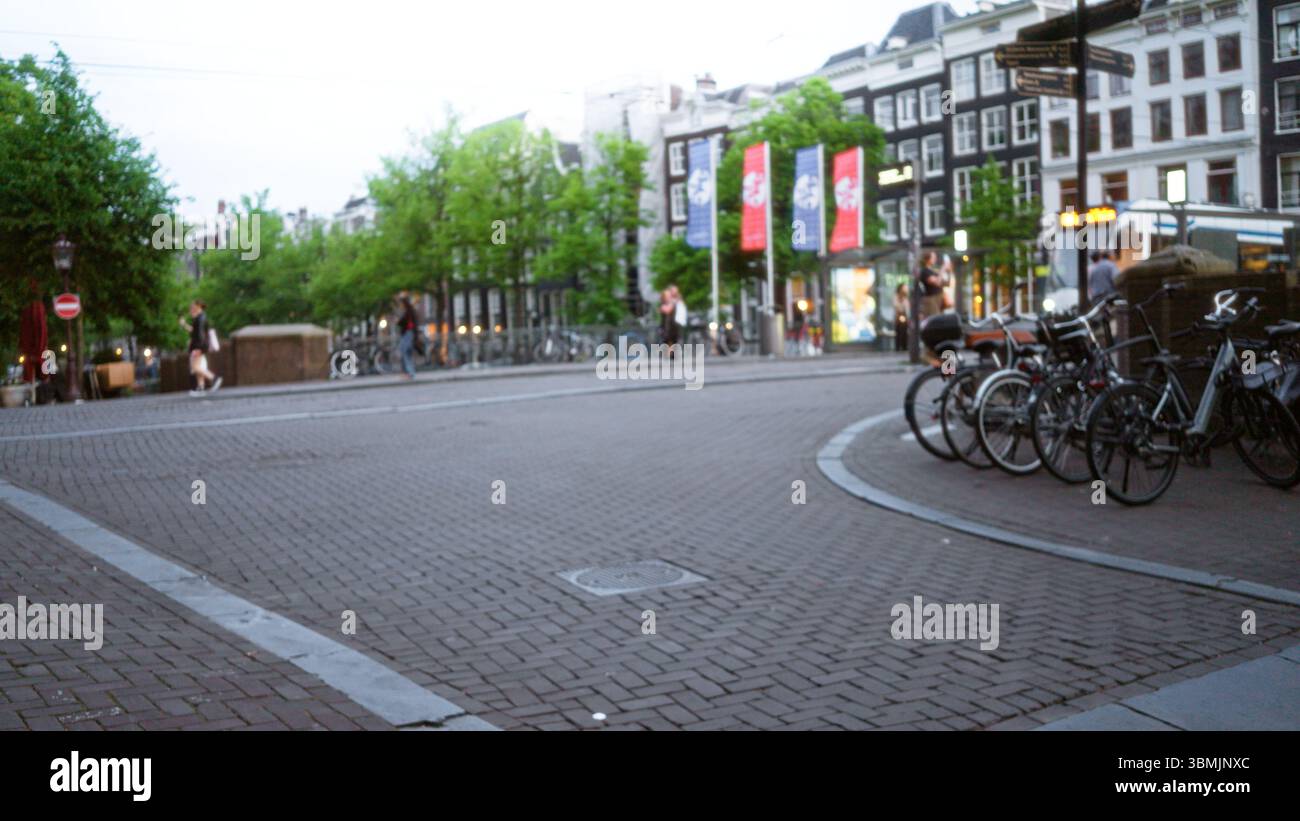 Blurred street scene in amsterdam with out-of-focus people walking and ...