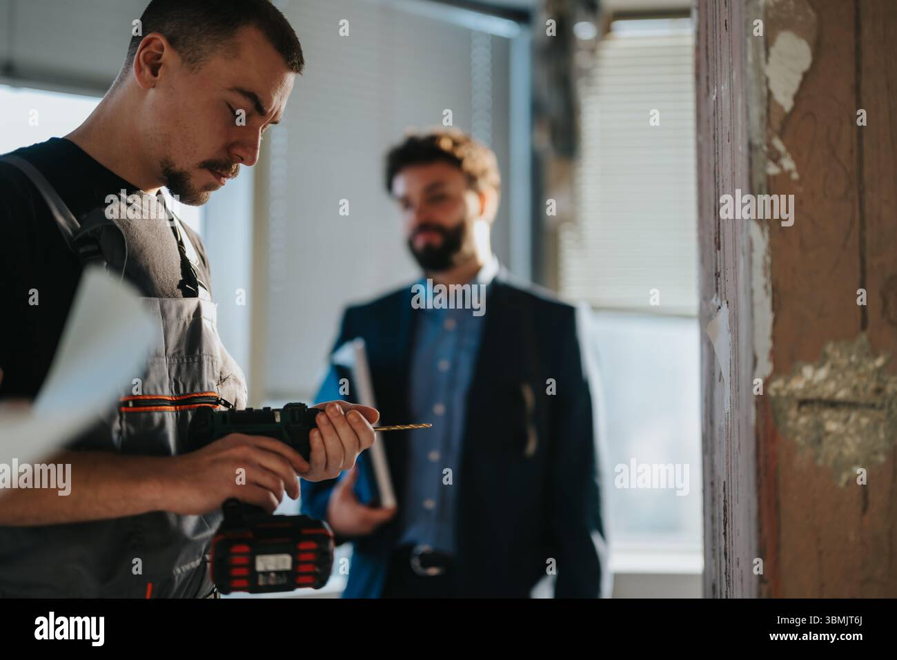 Professional Workers Collaborating on a Construction Project Within a Renovated Space Stock Photo