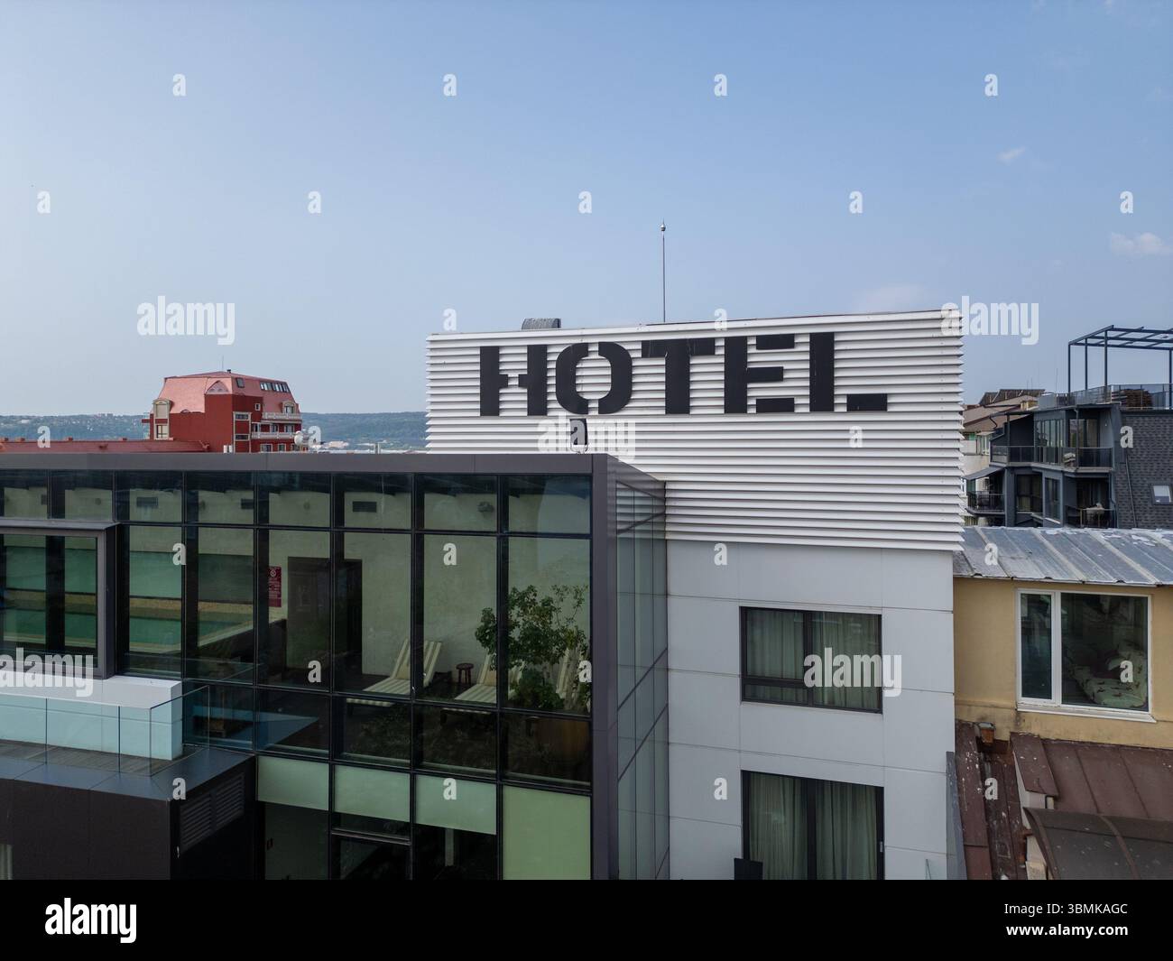 aerial video of a modern city hotel with large black HOTEL letters on ...