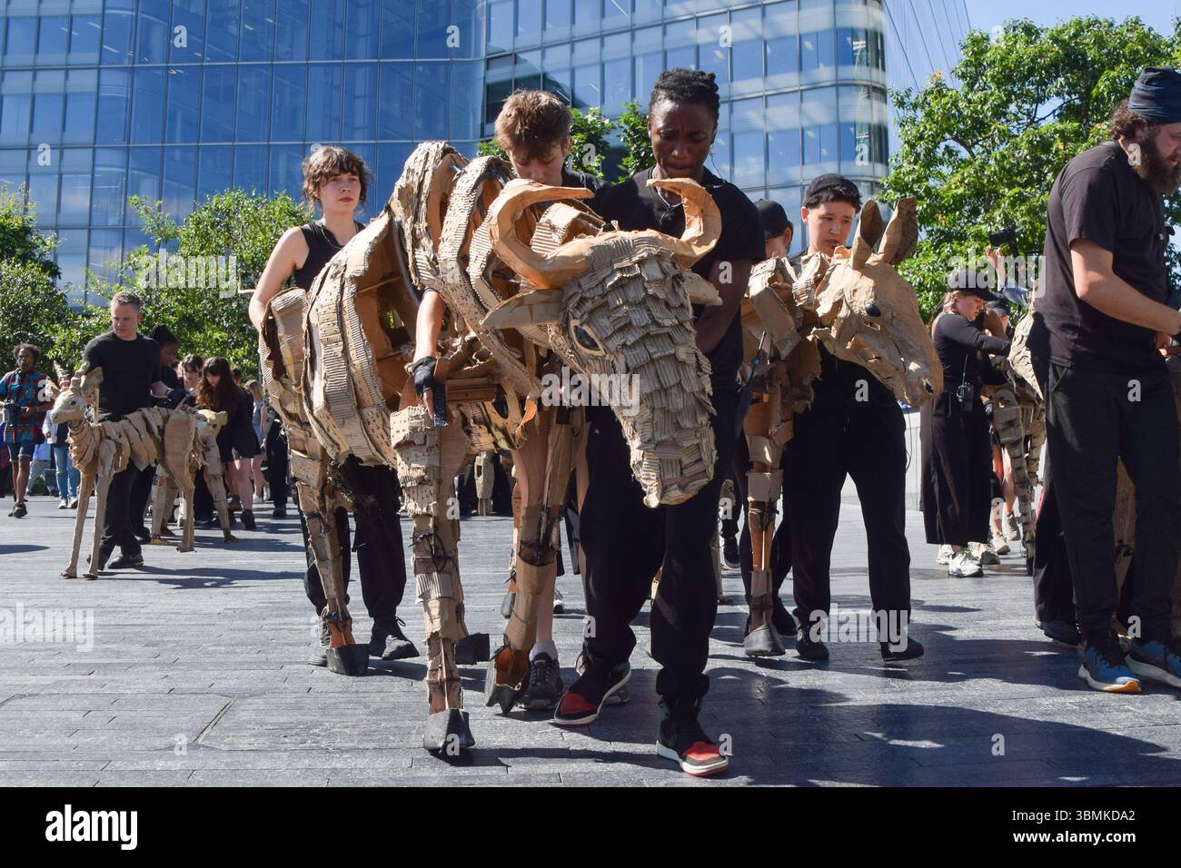 Puppetees Puppeteers take life-size animal puppets for a walk near Tower Bridge ...