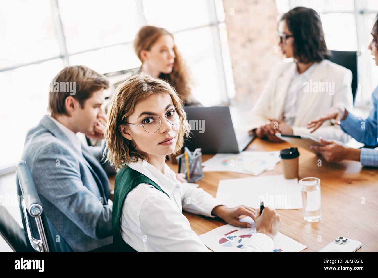 Business professionals collaborating during a team meeting in a modern ...