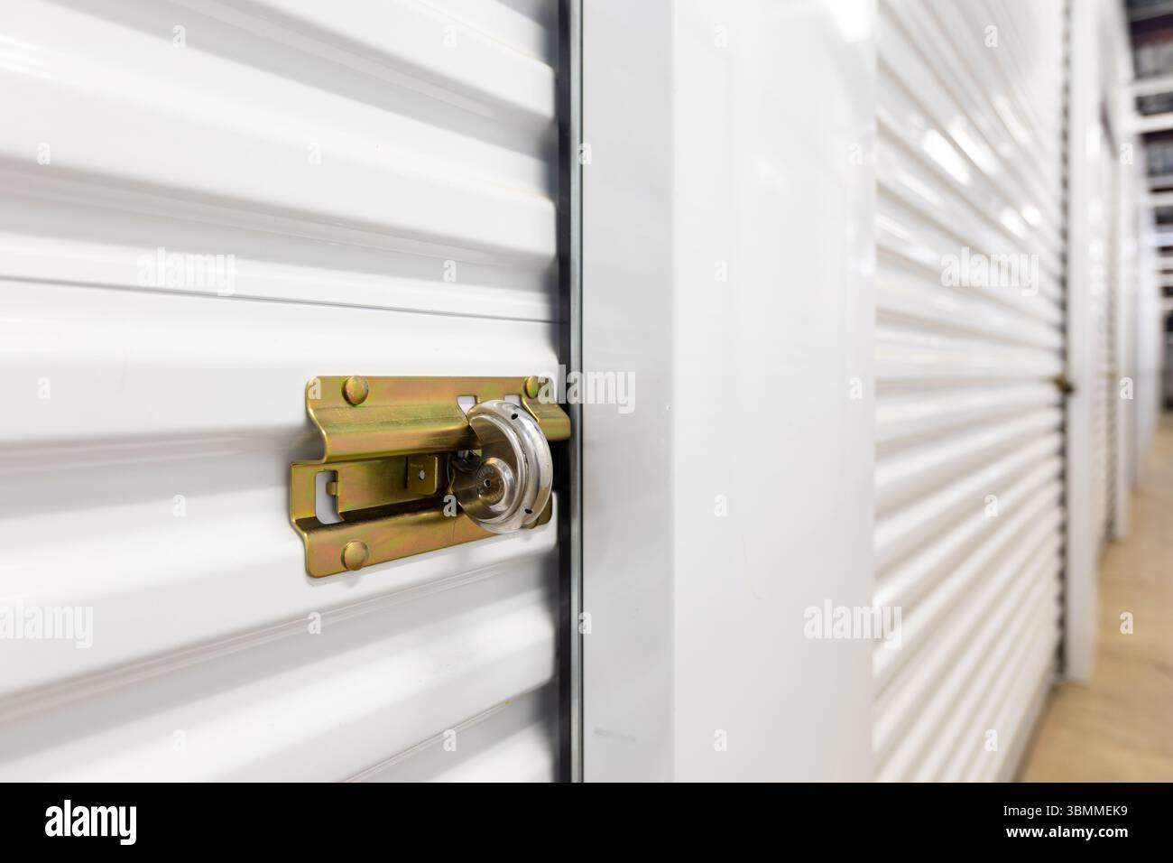 Key lock securing door on self storage unit. Stock Photo