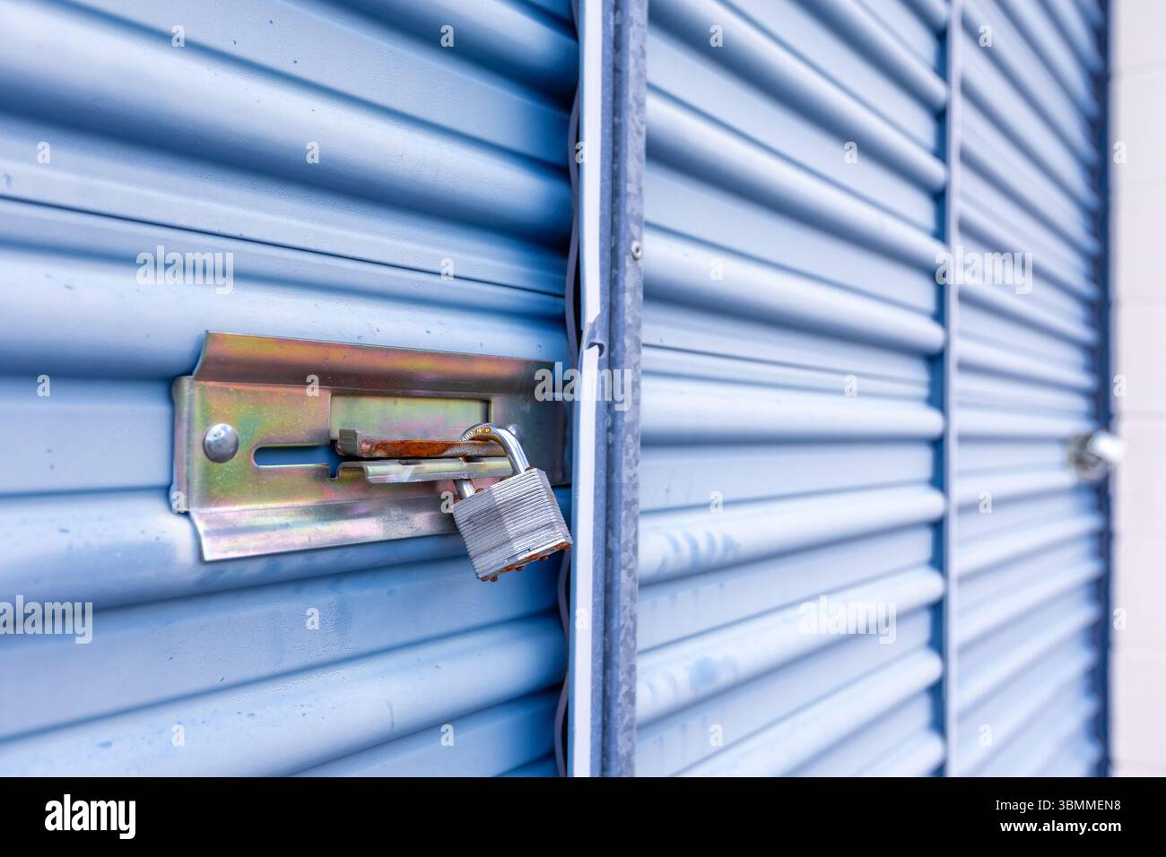 Key lock securing door on self storage unit. Stock Photo