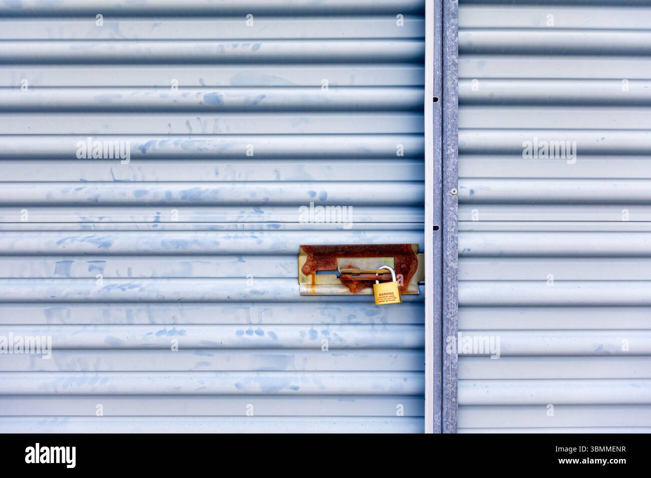 Key lock securing door on self storage unit. Stock Photo