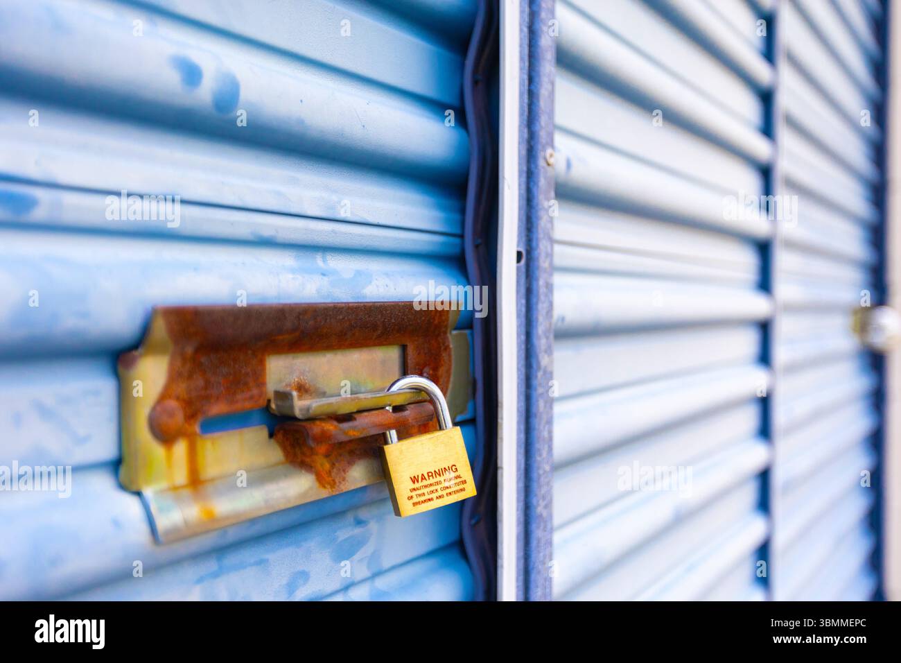 Key lock securing door on self storage unit. Stock Photo