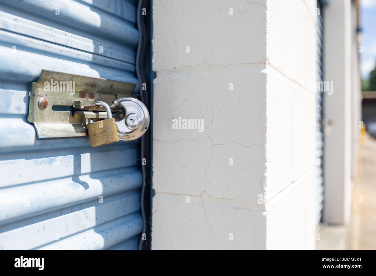 Key lock securing door on self storage unit. Stock Photo