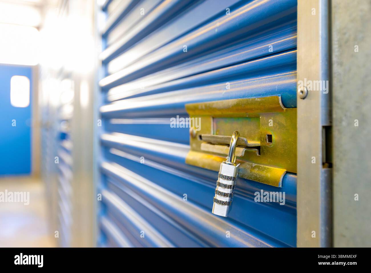 Combination lock securing door on self storage unit. Stock Photo