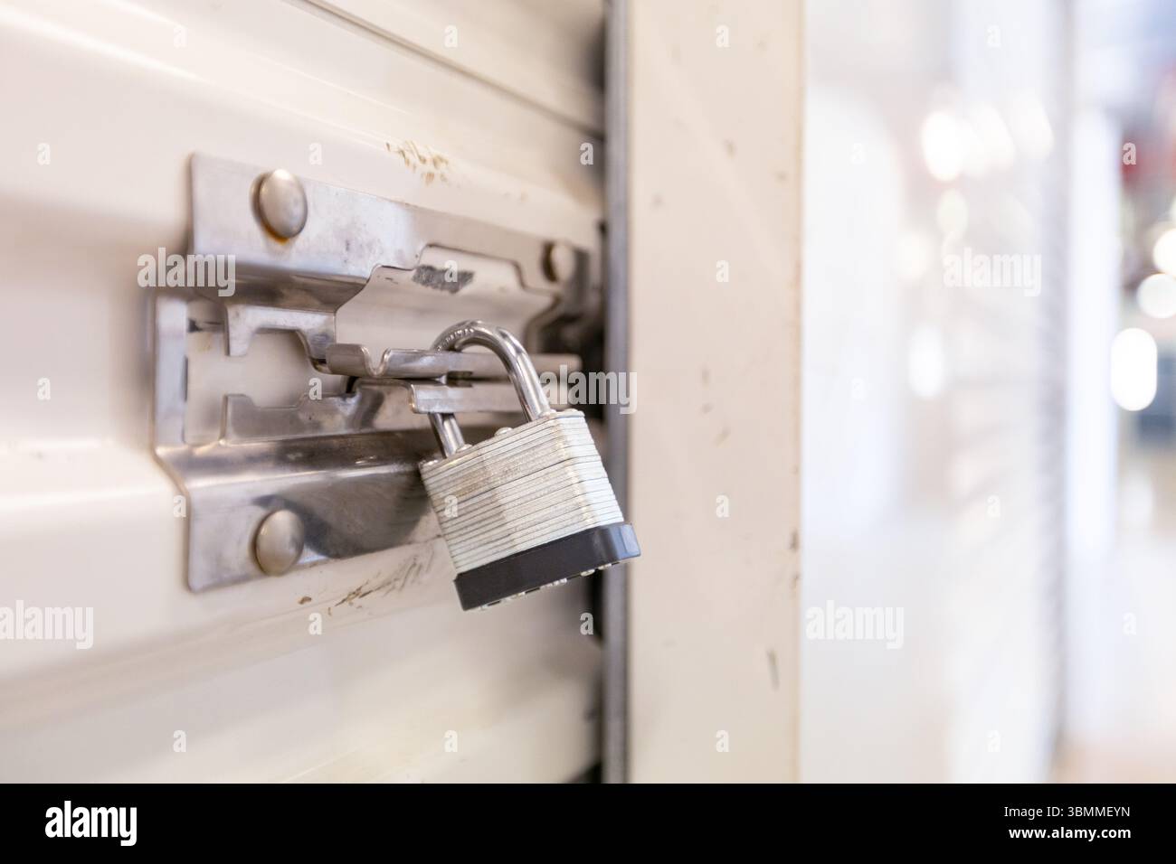 Key lock securing door on self storage unit. Stock Photo