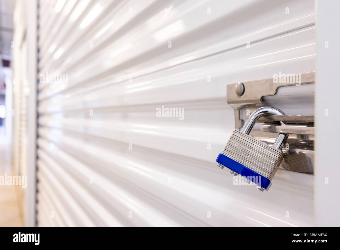 Key lock securing door on self storage unit. Stock Photo