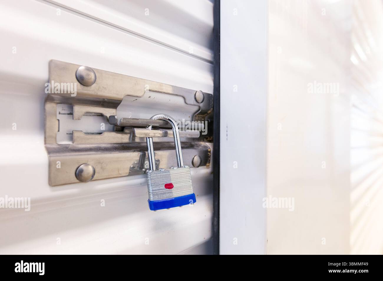 Key lock securing door on self storage unit. Stock Photo