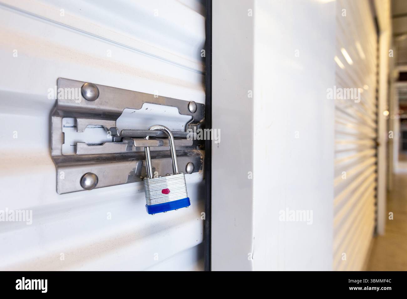 Key lock securing door on self storage unit. Stock Photo
