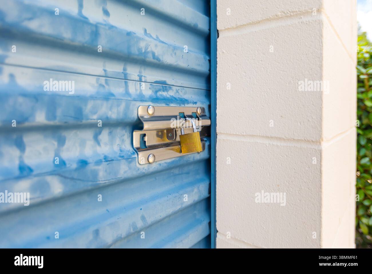 Key lock securing door on self storage unit. Stock Photo