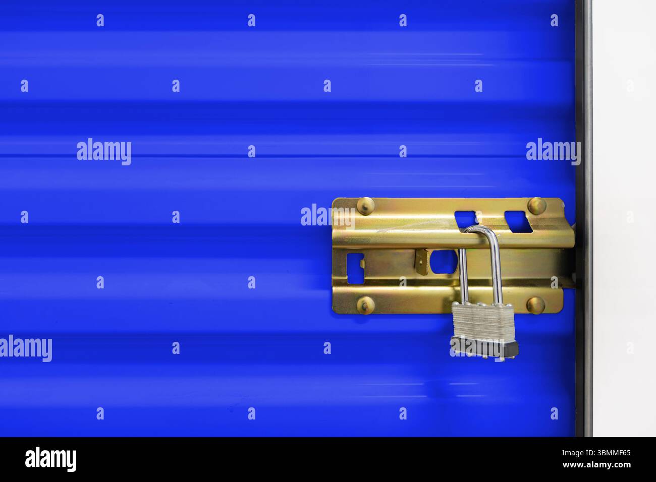 Key lock securing door on self storage unit. Stock Photo