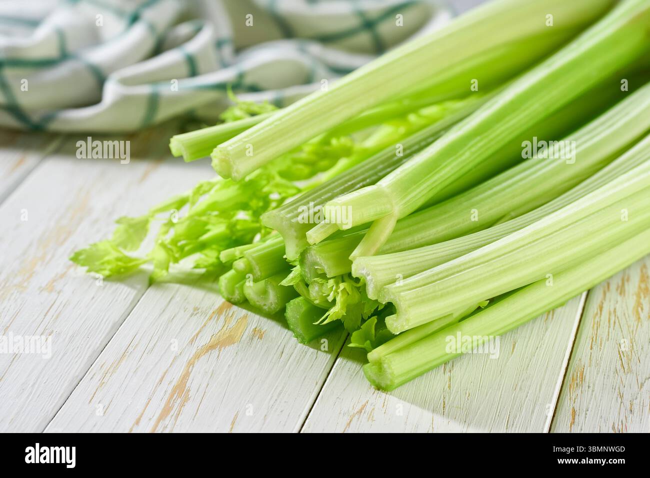 Celery stems and leaves on wooden table, selective focus. Stock Photo