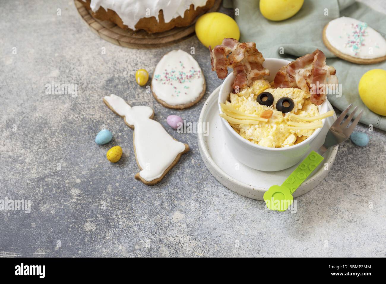 Easter breakfast idea. Scrambled eggs easter bunny on a stone background. Copy space Stock Photo