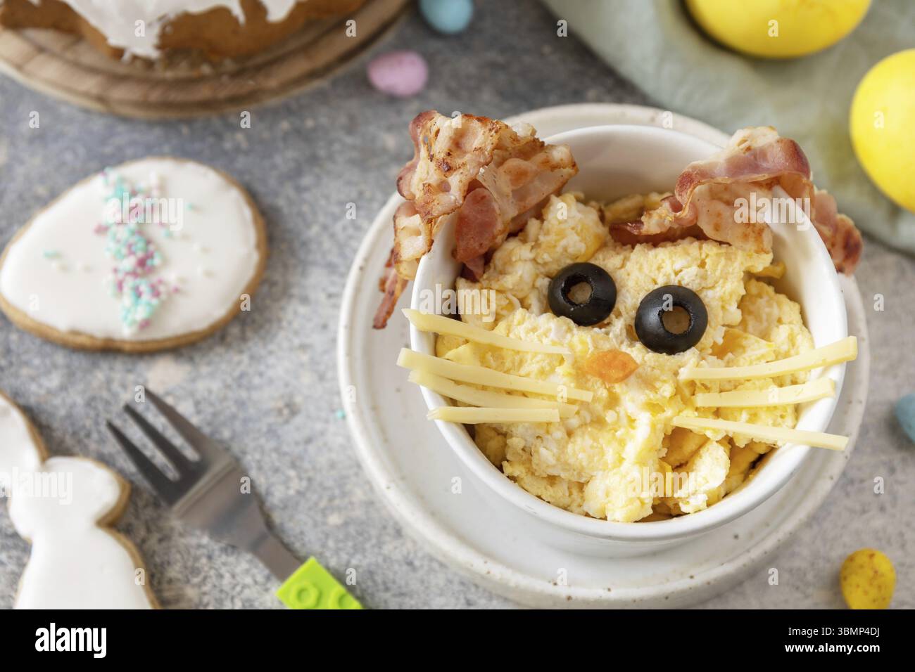 Scrambled eggs easter bunny on a stone background. Easter breakfast idea Stock Photo