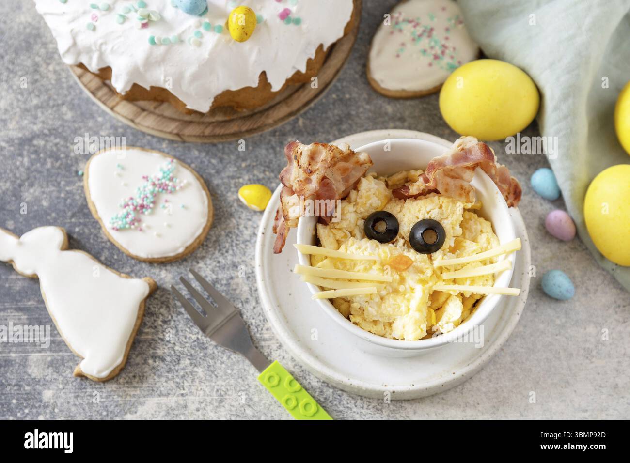 Easter breakfast idea. Scrambled eggs easter bunny on a stone background Stock Photo