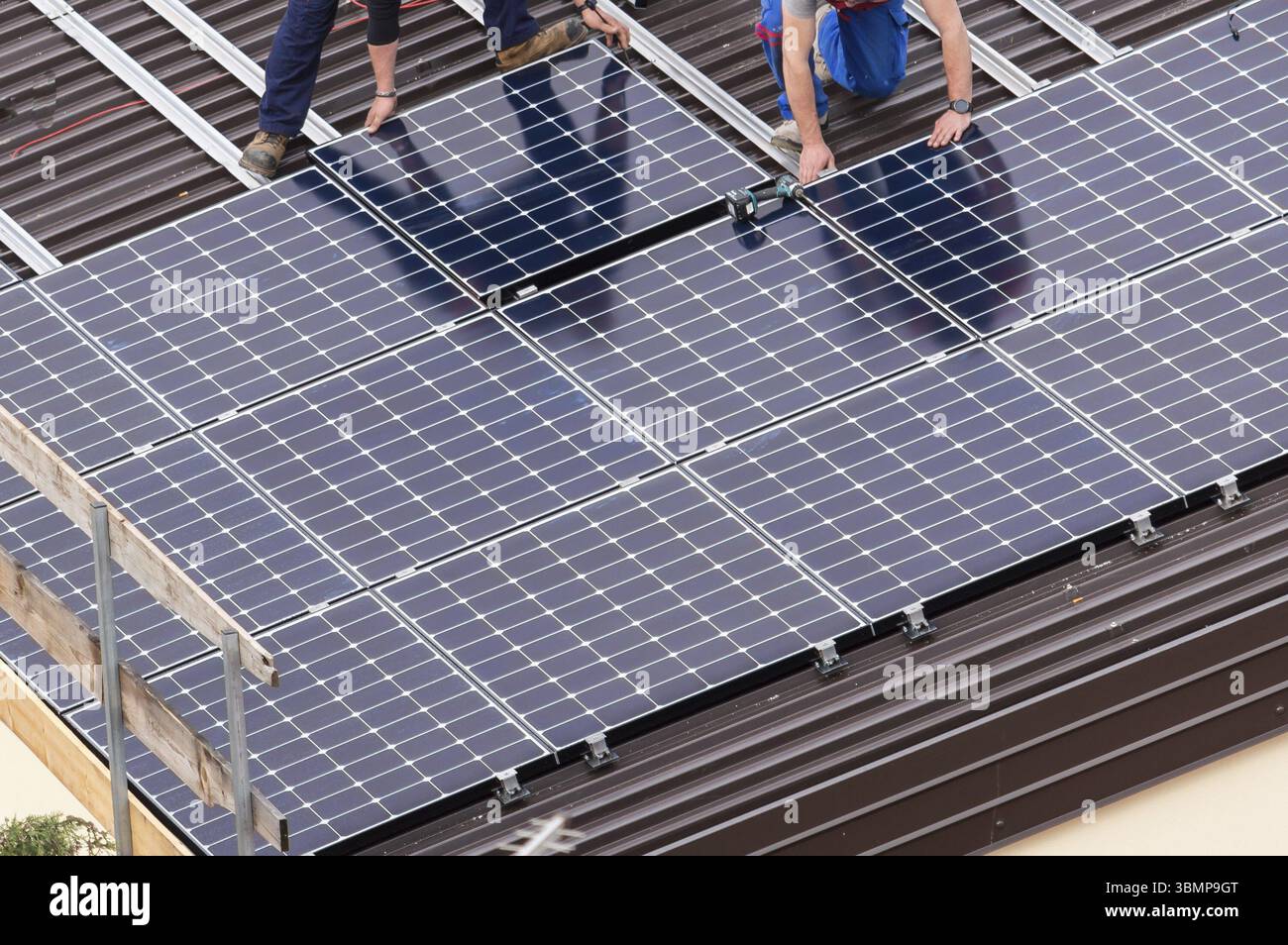 View of Installation of solar panels on a roof Stock Photo - Alamy
