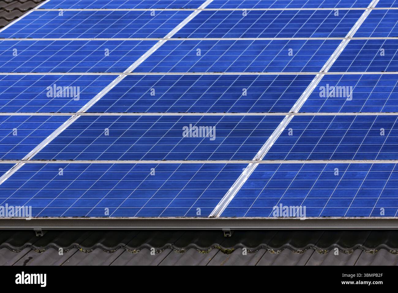 Private photovoltaic system with blue solar modules of a photovoltaic system on a private house, Germany, Europe Stock Photo