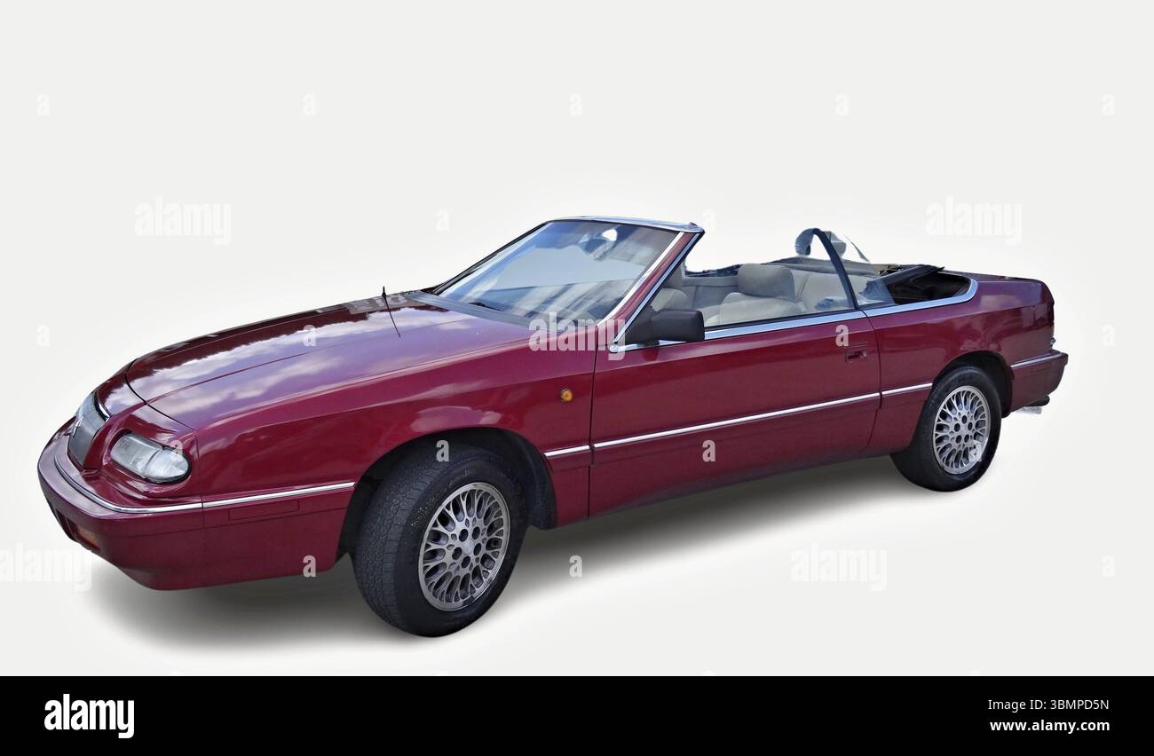 Classic red Chrysler LeBaron convertible car parked with open roof on white background, representing american automotive design Stock Photo